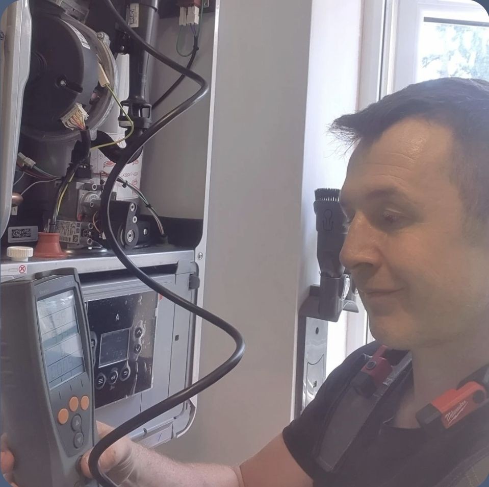 Gas Safe engineer carrying out a full boiler service using a flue gas analyser to check safety and efficiency Gas Safe engineer carrying out a full boiler service using a flue gas analyser to check safety and efficiency